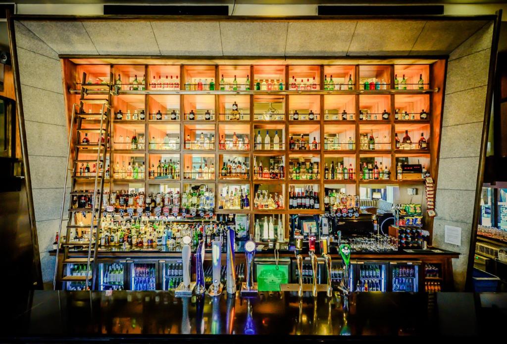 a bar with a lot of bottles of alcohol at Osprey Hotel in Naas
