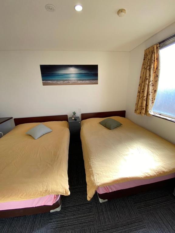 Postel nebo postele na pokoji v ubytování MR TOMO FUJI