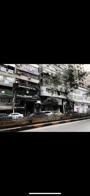 a large building with cars parked in front of it at المهندسين شقه سوبر لوكس - محى الدين ابو العز in Cairo