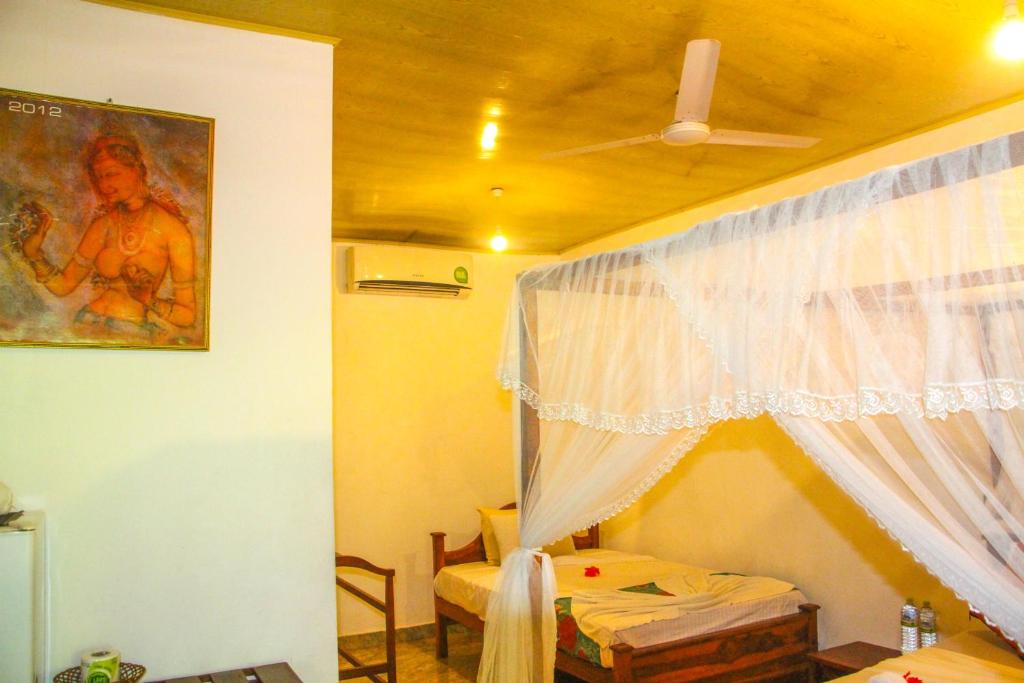 Postel nebo postele na pokoji v ubytování Kolon Resort Sigiriya
