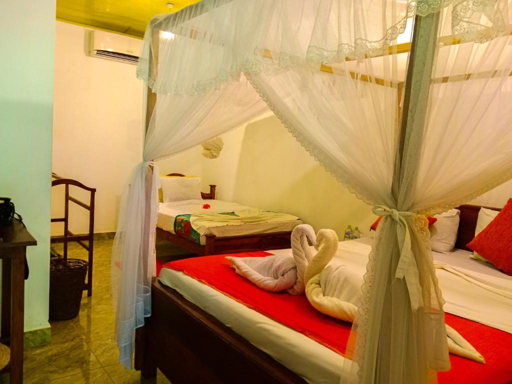 Postel nebo postele na pokoji v ubytování Kolon Resort Sigiriya