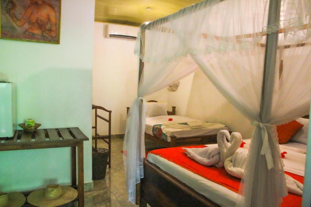 Postel nebo postele na pokoji v ubytování Kolon Resort Sigiriya