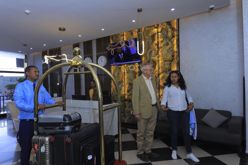 a group of people standing in a room with luggage at Zemilo Hotel Apartment in Addis Ababa