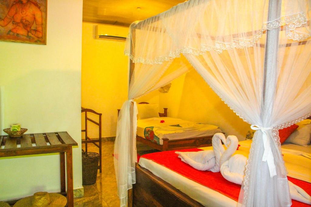 Postel nebo postele na pokoji v ubytování Kolon Resort Sigiriya