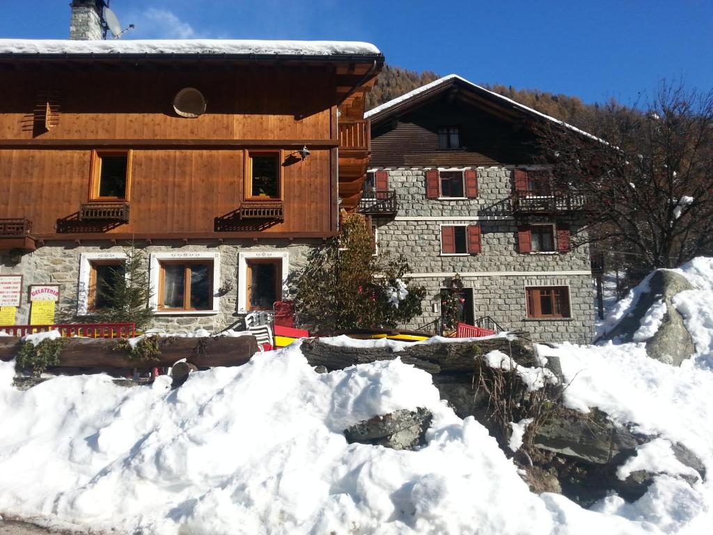a building with a pile of snow in front of it at Appartamento Monte Rosa in Champoluc