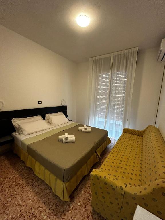 Postel nebo postele na pokoji v ubytování Hotel Perla