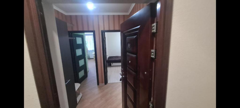 a room with wooden doors and a hallway at CreangaView in Chişinău