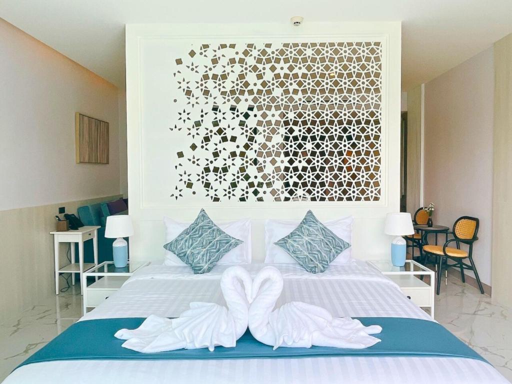 Postel nebo postele na pokoji v ubytování Sand Dance Hotel