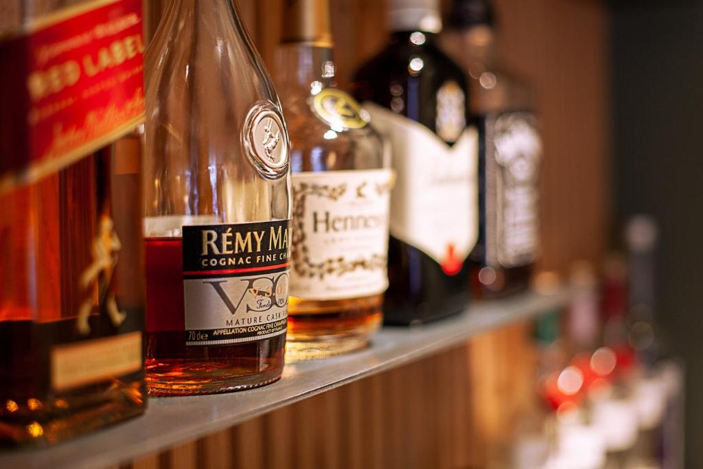a row of bottles of alcohol sitting on a shelf at Hotel am Jakobsmarkt in Nuremberg