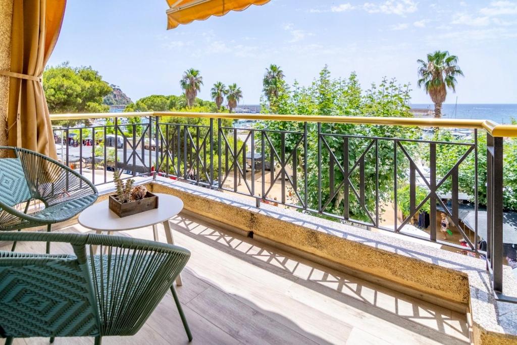 a balcony with chairs and a view of the ocean at SeaHomes Vacations - NAUTIC MARITIME Apt in Blanes