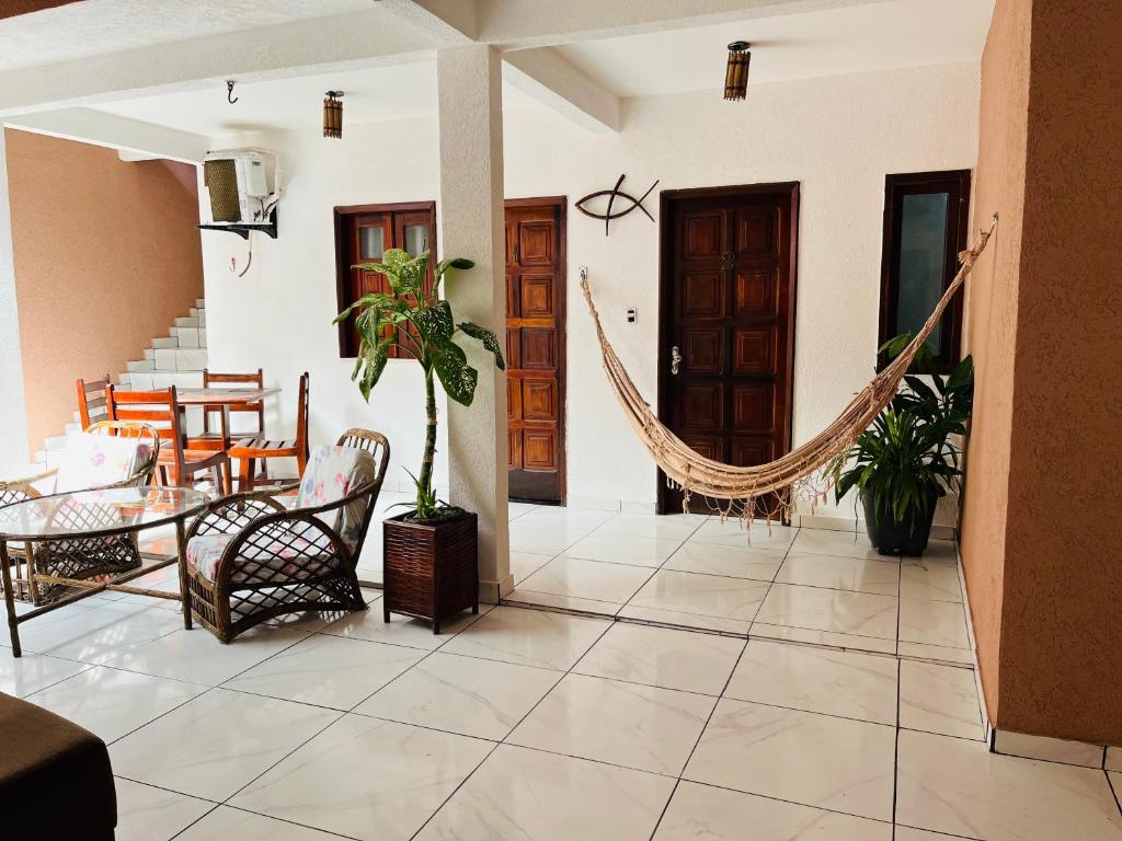 a living room with a hammock in a house at Pousada Timbalada in Morro de São Paulo