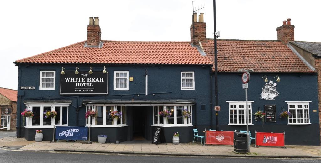 a blue building on the corner of a street at The White Bear Hotel in Bedale