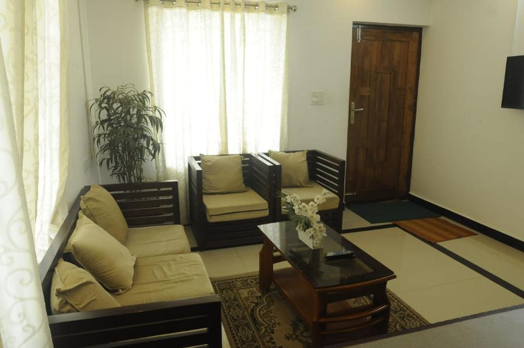 a living room with a couch and a coffee table at Mistyplanet vagamon in Vagamon