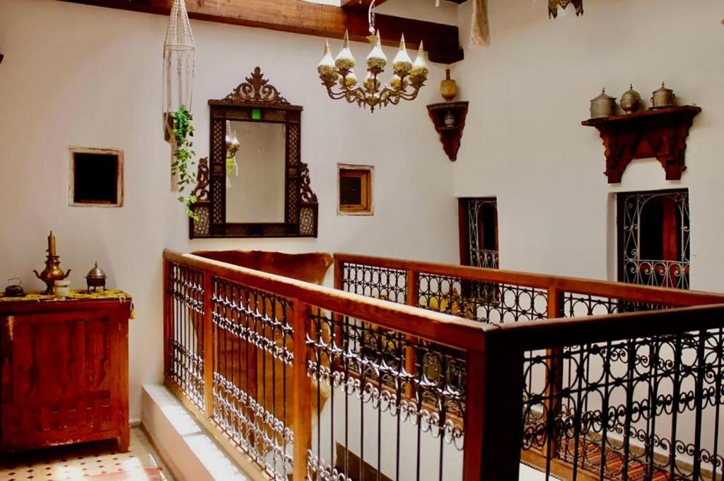 a room with a wooden railing and a mirror at DAR Naima in Fez