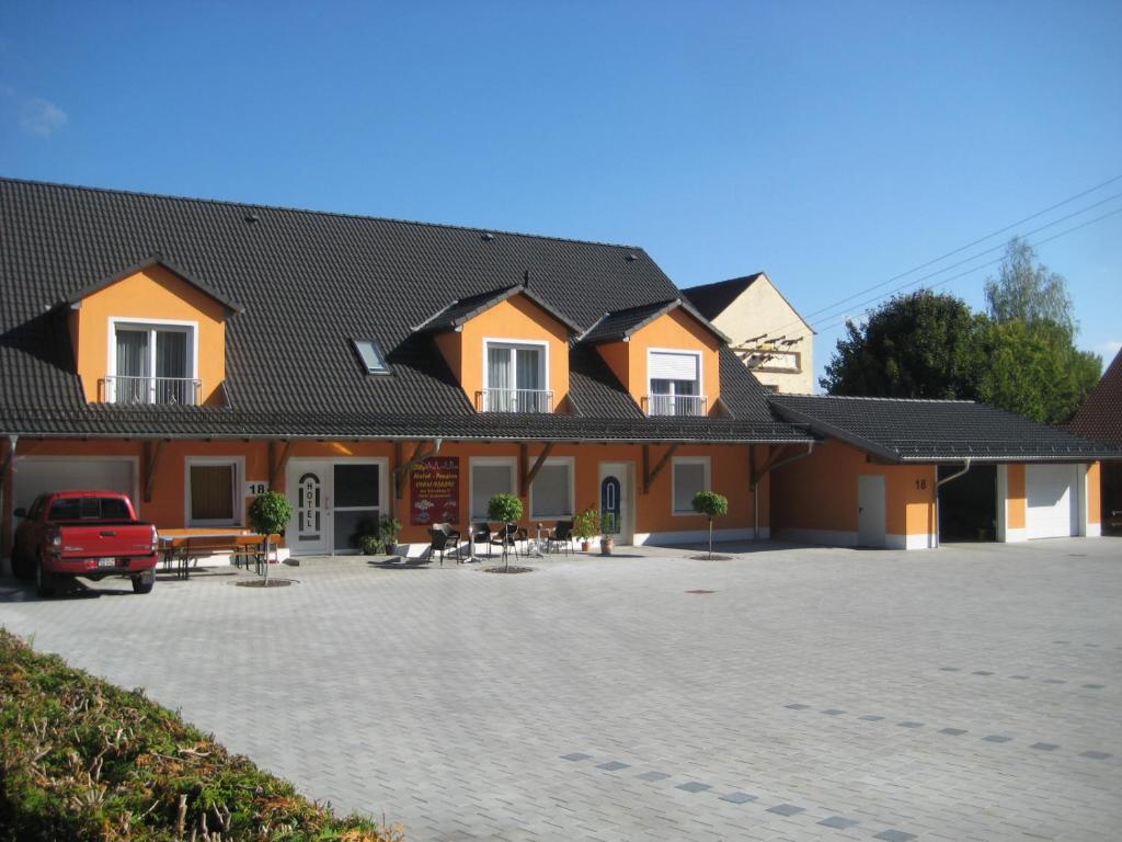 una casa con un coche aparcado delante de ella en City-Hotel-Pension-Grafenwöhr en Grafenwöhr