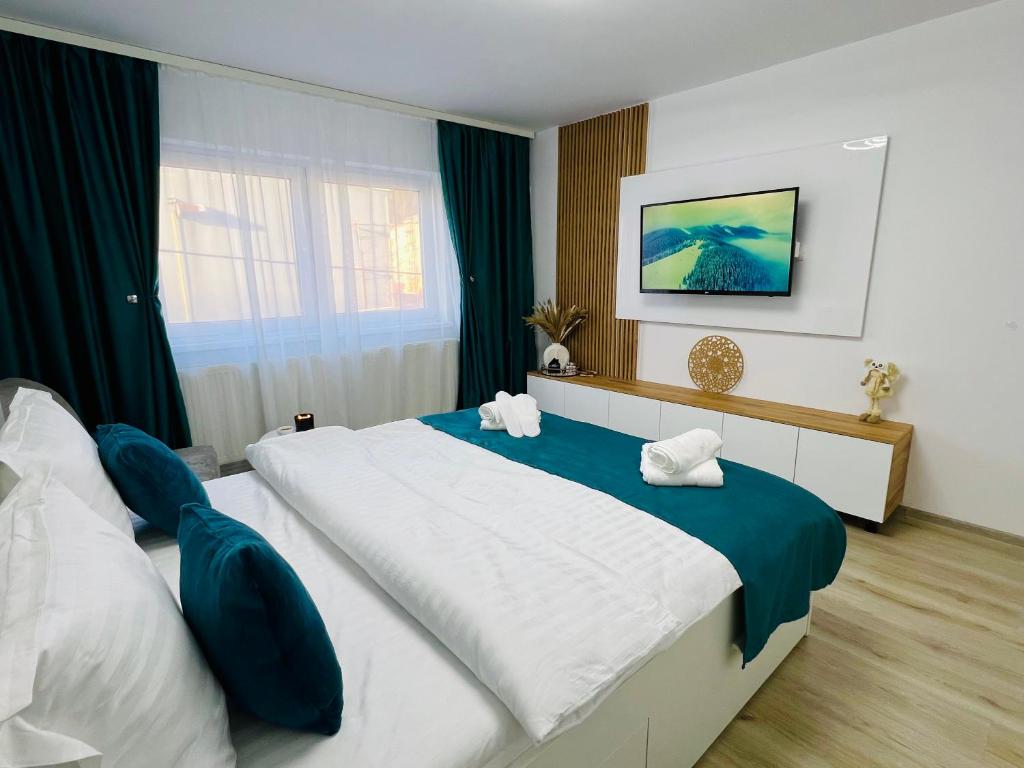 a bedroom with a large bed and a window at MarbleHome~Straja/Lupeni in Lupeni