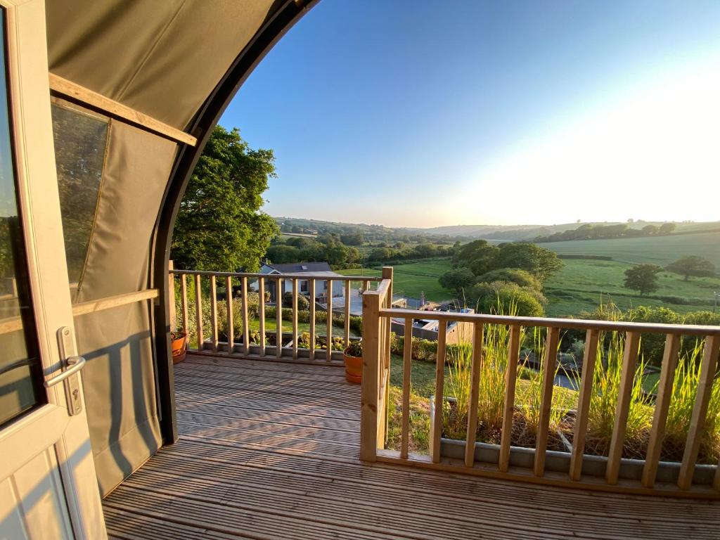 a balcony with a view of the countryside from a house at Beautiful bolt hole for 2 with breathtaking views in Kingsbridge