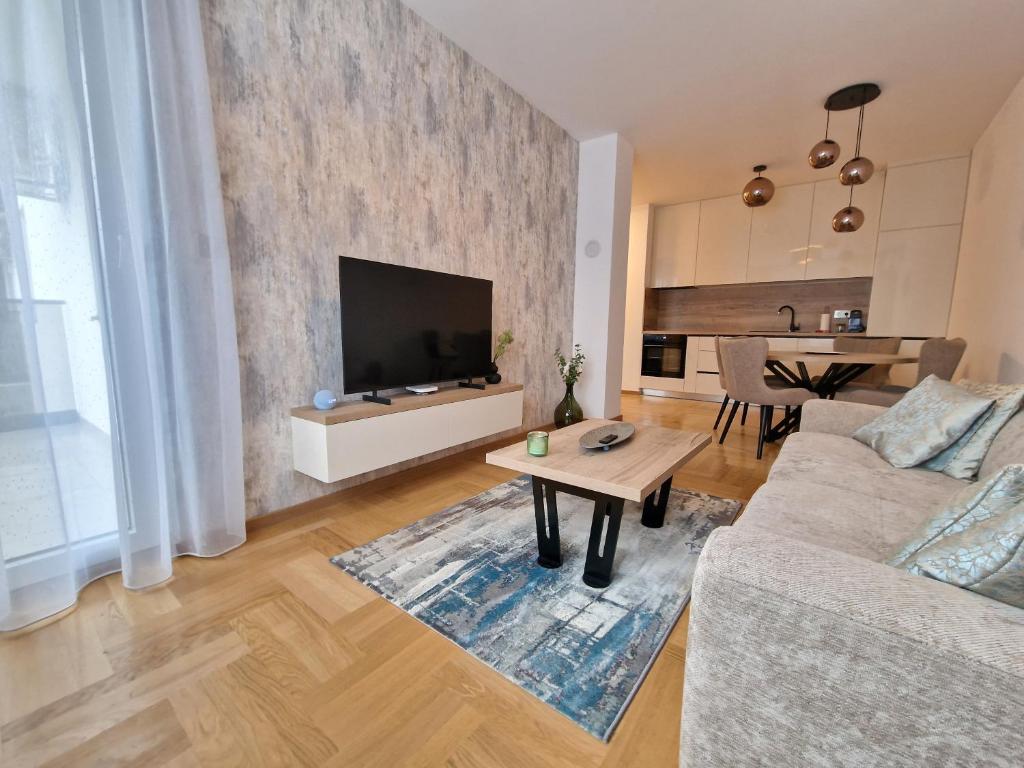 a living room with a couch and a table at Moments Banja Luka in Banja Luka
