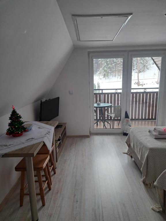 a room with two beds and a christmas tree in it at Zakątek DoriMaks in Zawoja