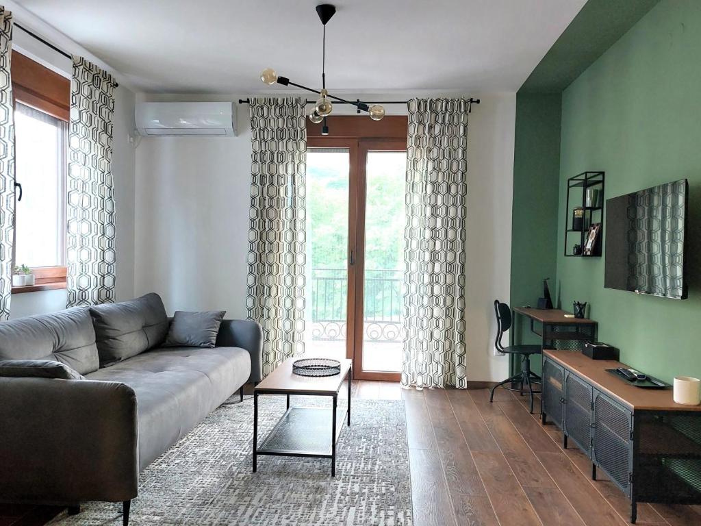 a living room with a couch and a table at Tilia Home in Vrnjačka Banja