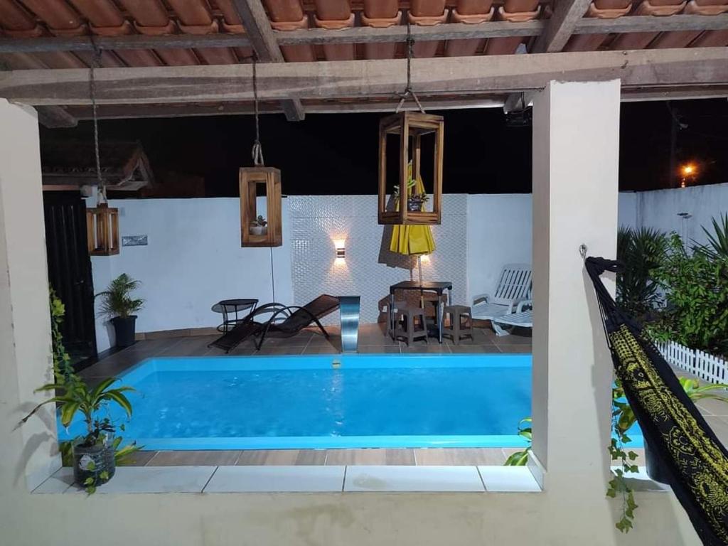 a swimming pool in a villa at night at Rochedo Casa de Praia in Nova Viçosa