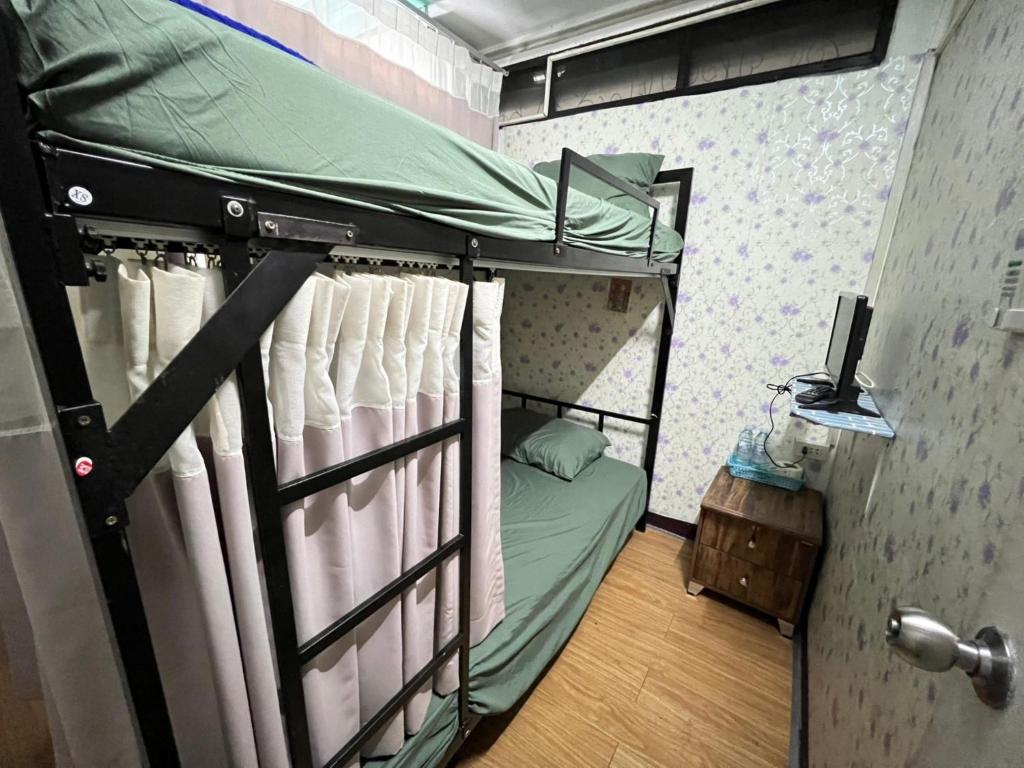 a bedroom with a bunk bed with a computer on it at Natcha Place Rangsit Donmuang in Ban Talat Rangsit