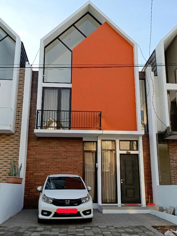 a white car parked in front of a house at Orange house Villa in Dau
