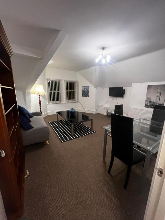 a living room with a couch and a table at No 5 - LARGE 1 BED NEAR SEFTON PARK AND LARK LANE in Liverpool