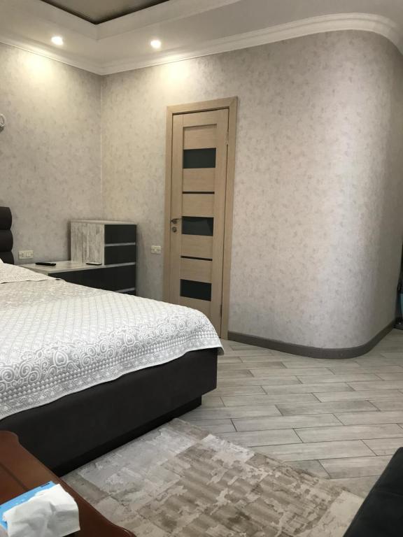 Un dormitorio con una cama y una puerta. en SM Apartment en Ereván