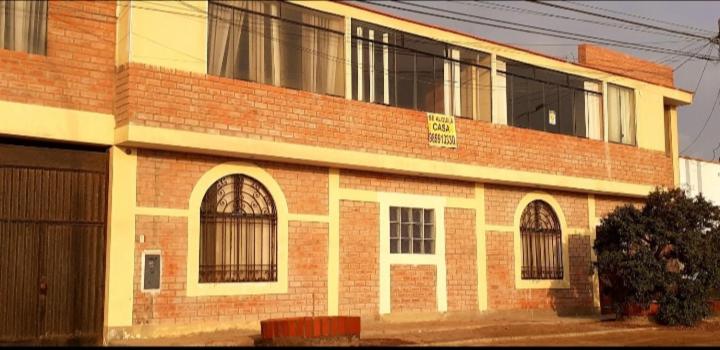 a brick building with barred windows on the side of it at Alojamiento Punta Negra in Punta Negra