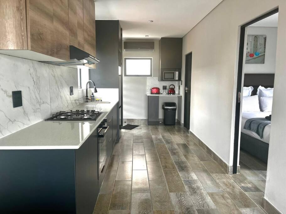a kitchen with a counter and a bed in a room at 14 on Lawrence in Durban