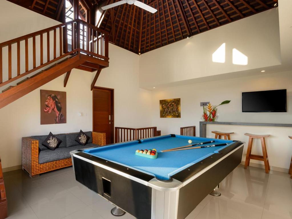 a pool table in the middle of a living room at Echo Beach Townhouses in Canggu