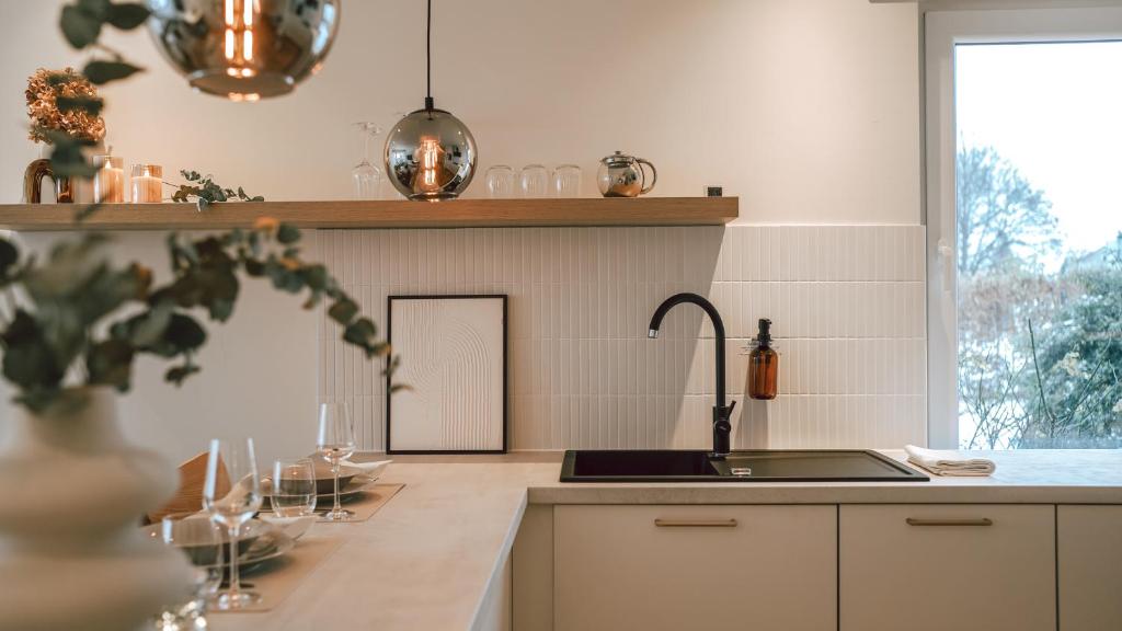a kitchen with a sink and a counter with a window at Appartement Grünoase - zentrumsnah in Detmold