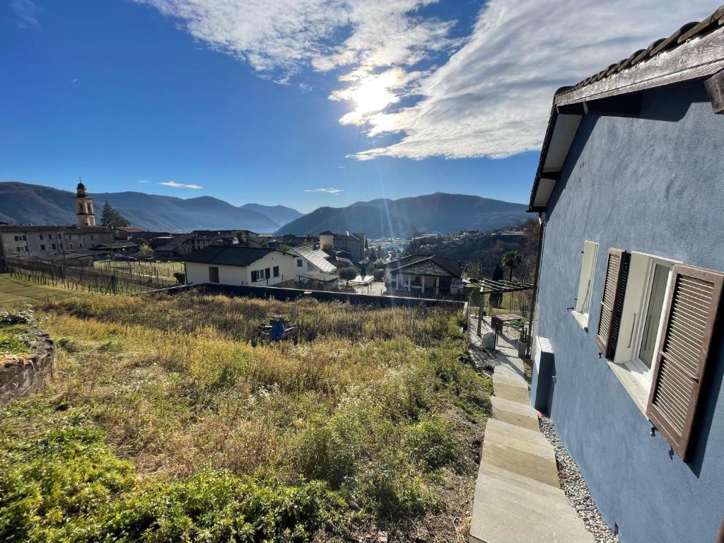 a blue building with a view of the mountains at Escapade Ticino in Neggio
