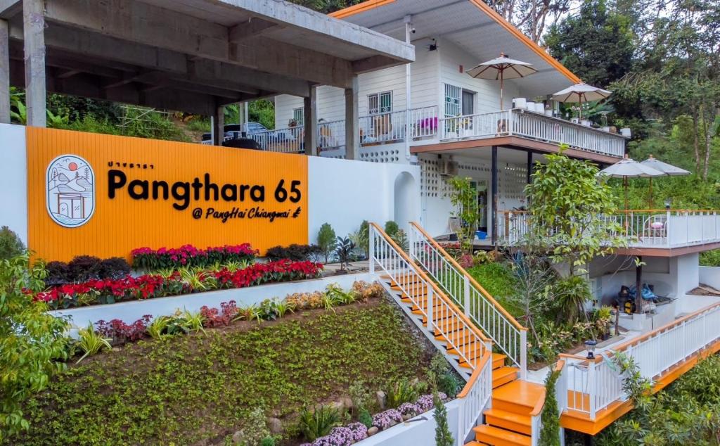 a building with a sign in front of it at Pangthara65 ปางธารา ณ ปางไฮ เชียงใหม่ in Doi Saket