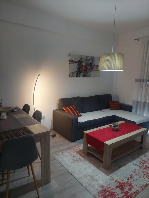 a living room with a couch and a table at Apartman Tea in Kupres