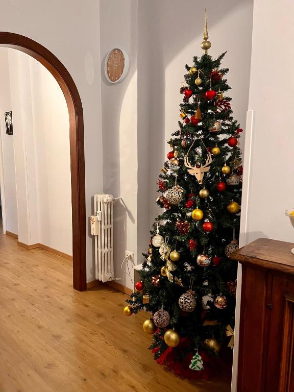 a christmas tree with ornaments on it in a room at Flaminio Luxury Home - City Center in Rome