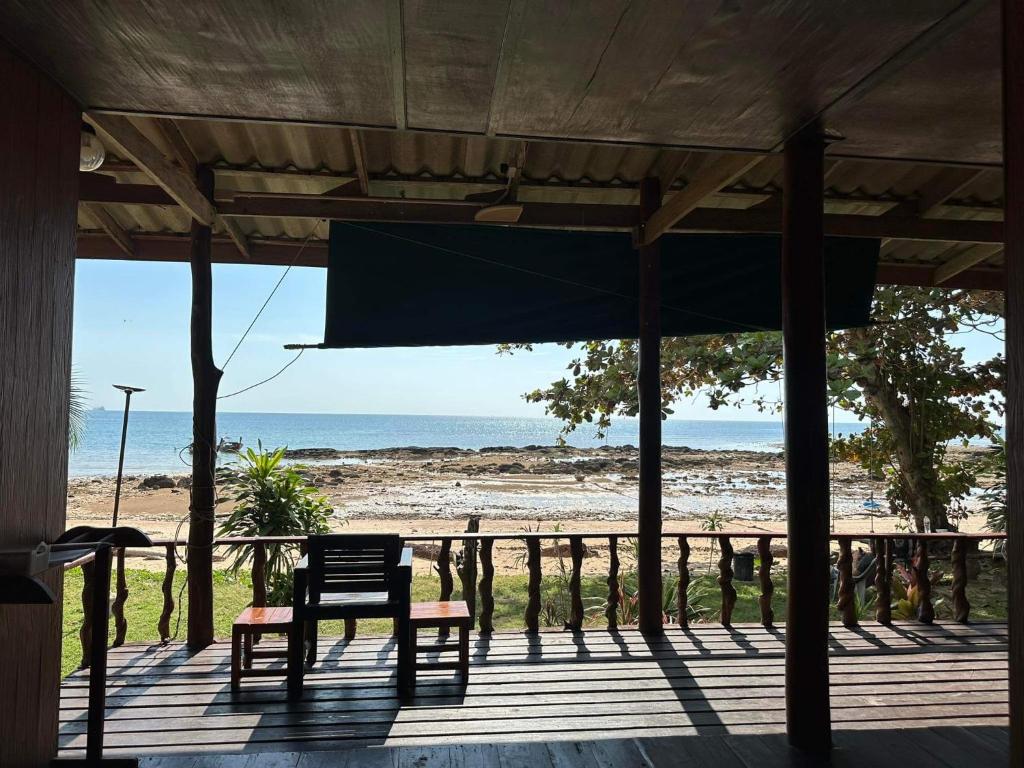 a porch with a bench and a view of the beach at Libong Garden Beach in Ko Libong