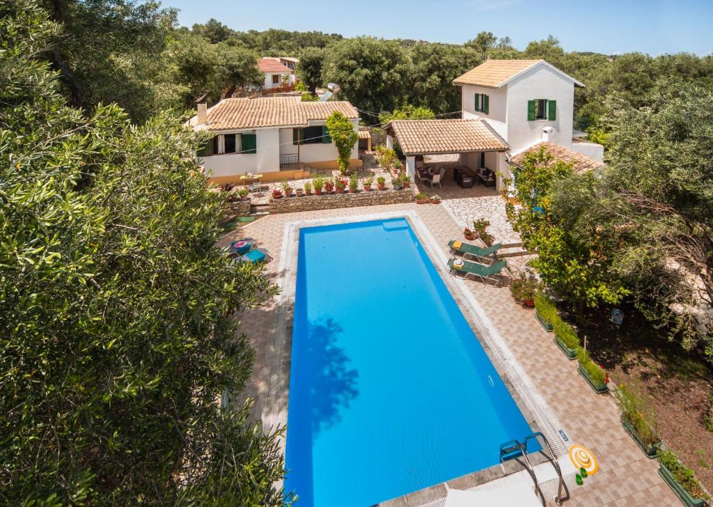 an overhead view of a swimming pool in front of a house at Marguerita House in Georgoutsátika