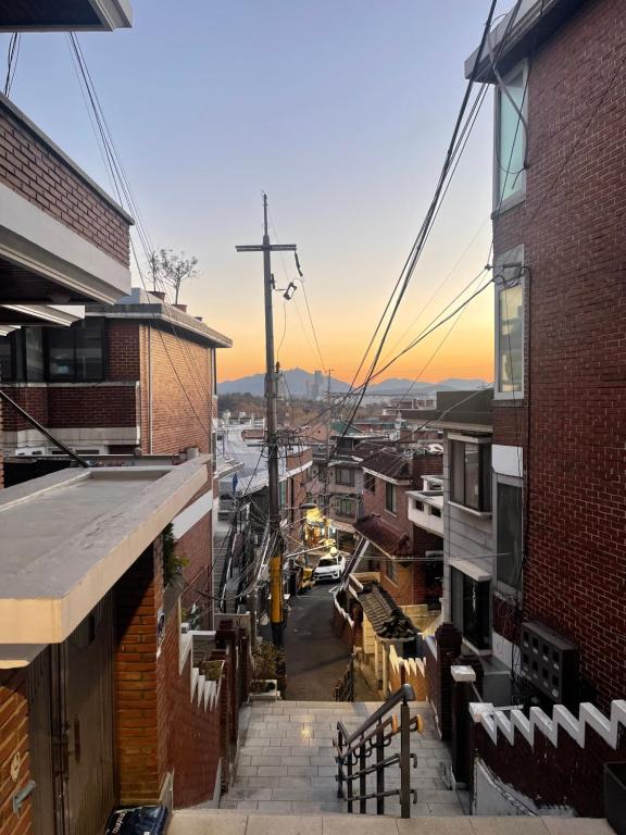 a view of a city with a sunset in the background at Cozy Private Home Newly Renovated in Seoul