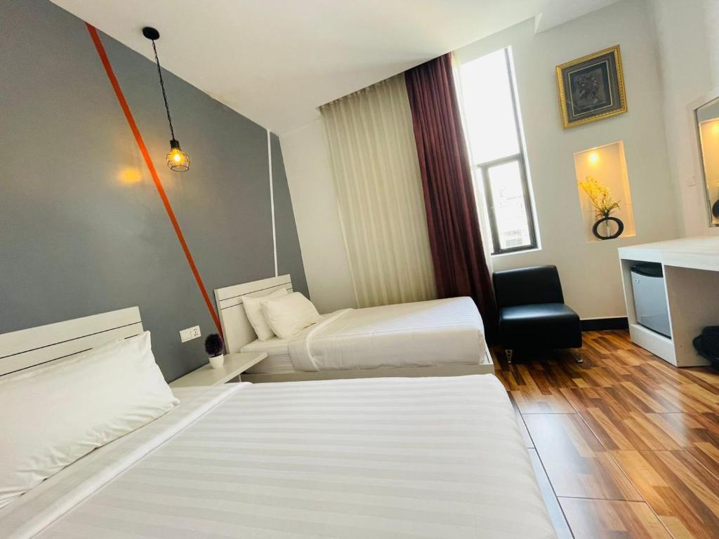 Postel nebo postele na pokoji v ubytování DE Hotel