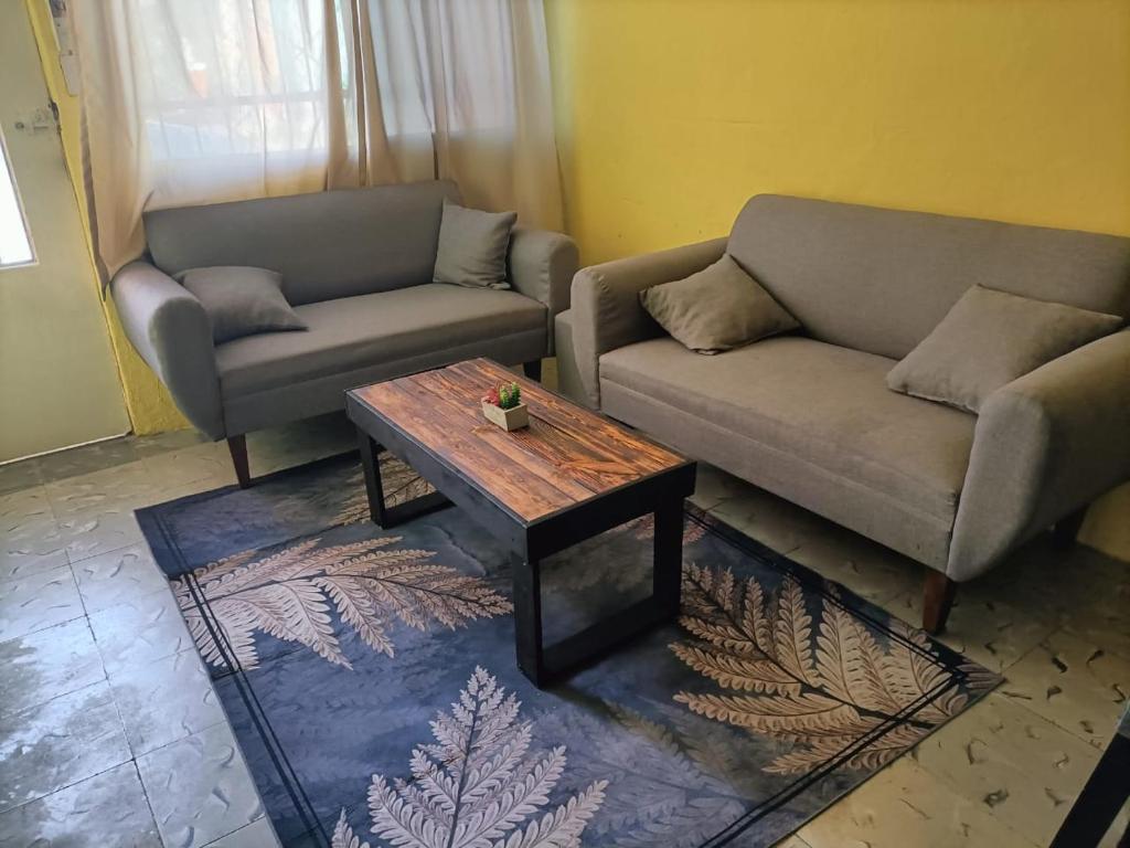 a living room with two couches and a coffee table at La Preciosa Casa Andaluza in Mérida