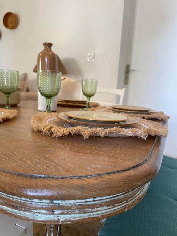 a wooden table with two wine glasses on top of it at Ô sparolland in Saint-Mandrier-sur-Mer