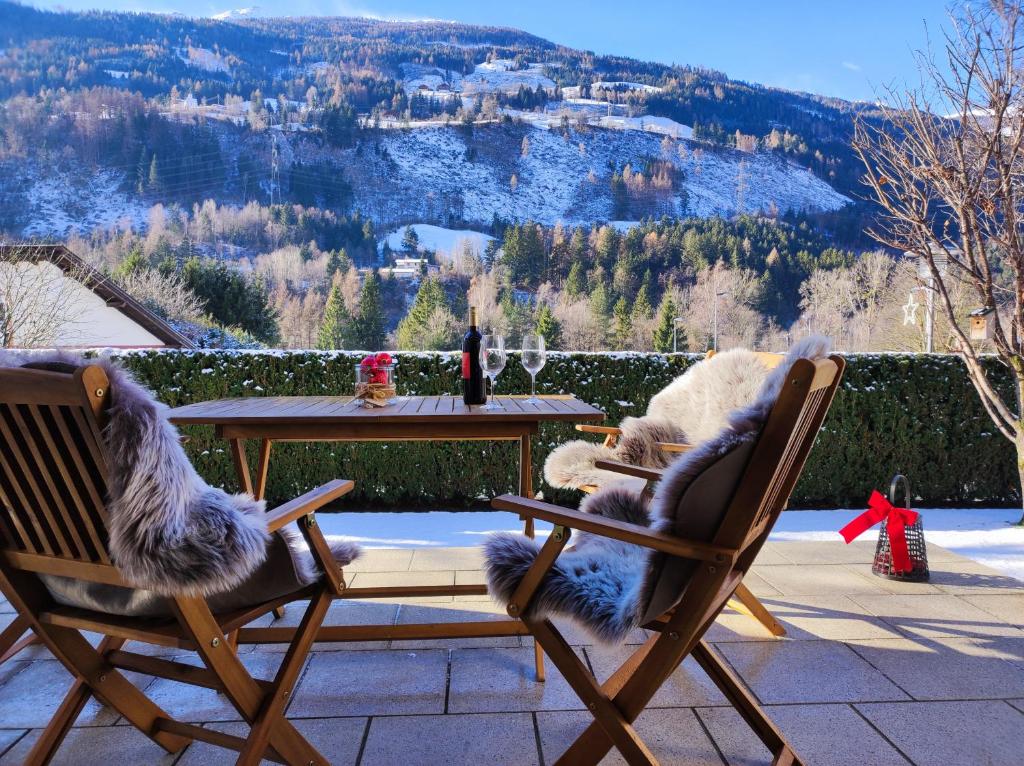 Dos sillas y una mesa con vista a una montaña. en Apartment Ploner, en Ainet