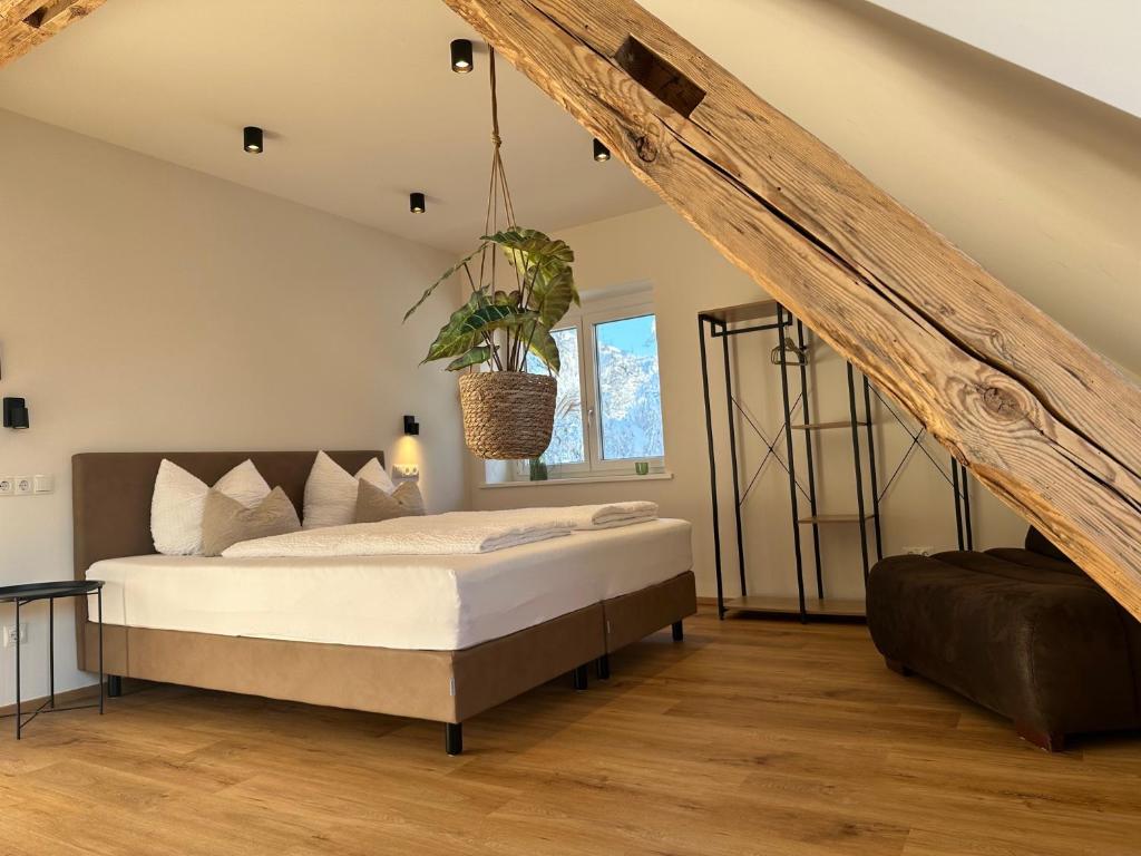 a bedroom with a bed with a potted plant on it at Gasthof - Auszeit im Bad Diezlings - Adults only in Hörbranz