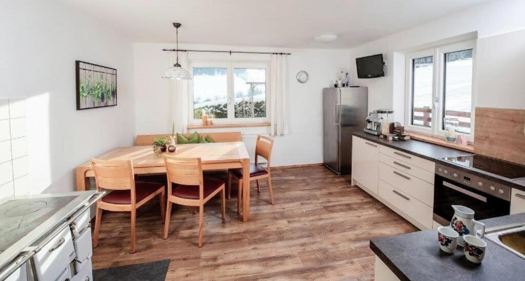 a kitchen with a table and a dining room at Haus Kirchgasser in Altenmarkt im Pongau