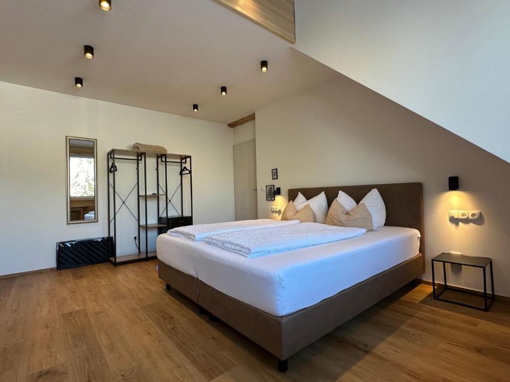 a bedroom with a large white bed in a room at Gasthof - Auszeit im Bad Diezlings - Adults only in Hörbranz
