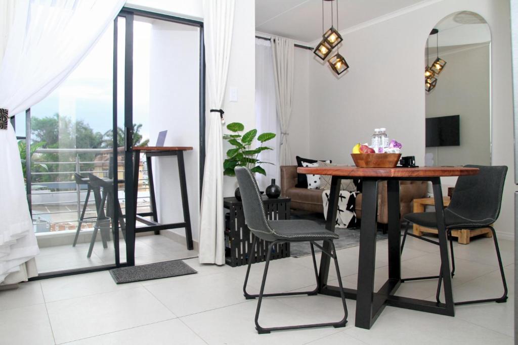 a dining room with a table and chairs at Sublime - By LaSerene - Carlswald in Midrand