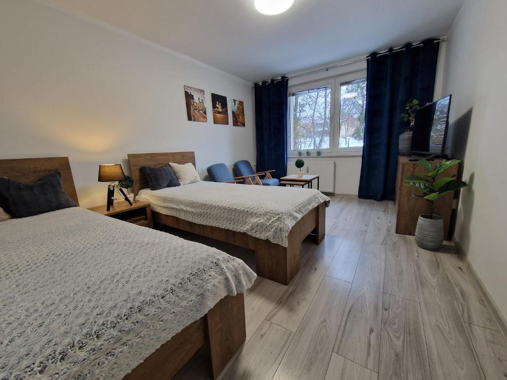 Postel nebo postele na pokoji v ubytování Apartament w Śródmieściu