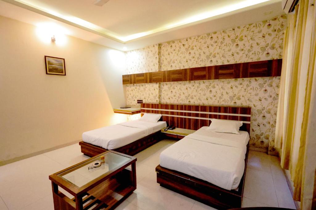 Postel nebo postele na pokoji v ubytování Hotel Sharveen Classic-inn